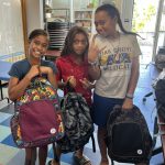 three girls with backpacks