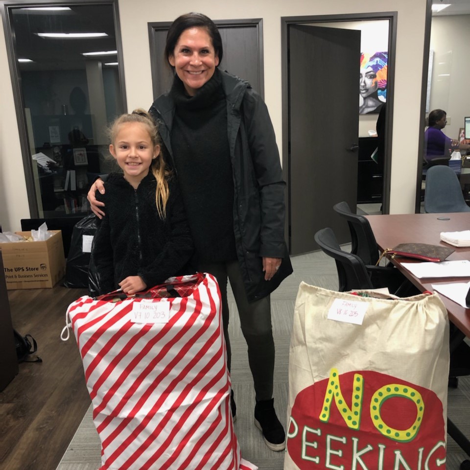 mother and daughter with holiday gifts