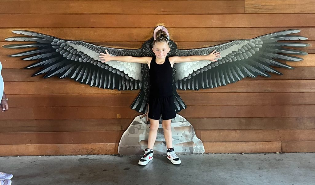 Summer Camps Girl in front of large bird model